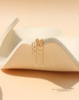 Gold stud earrings with freshwater pearls, chain link details, and a modern minimalist design, featuring the Alex Pearl Stud Earrings displayed in warm natural light.