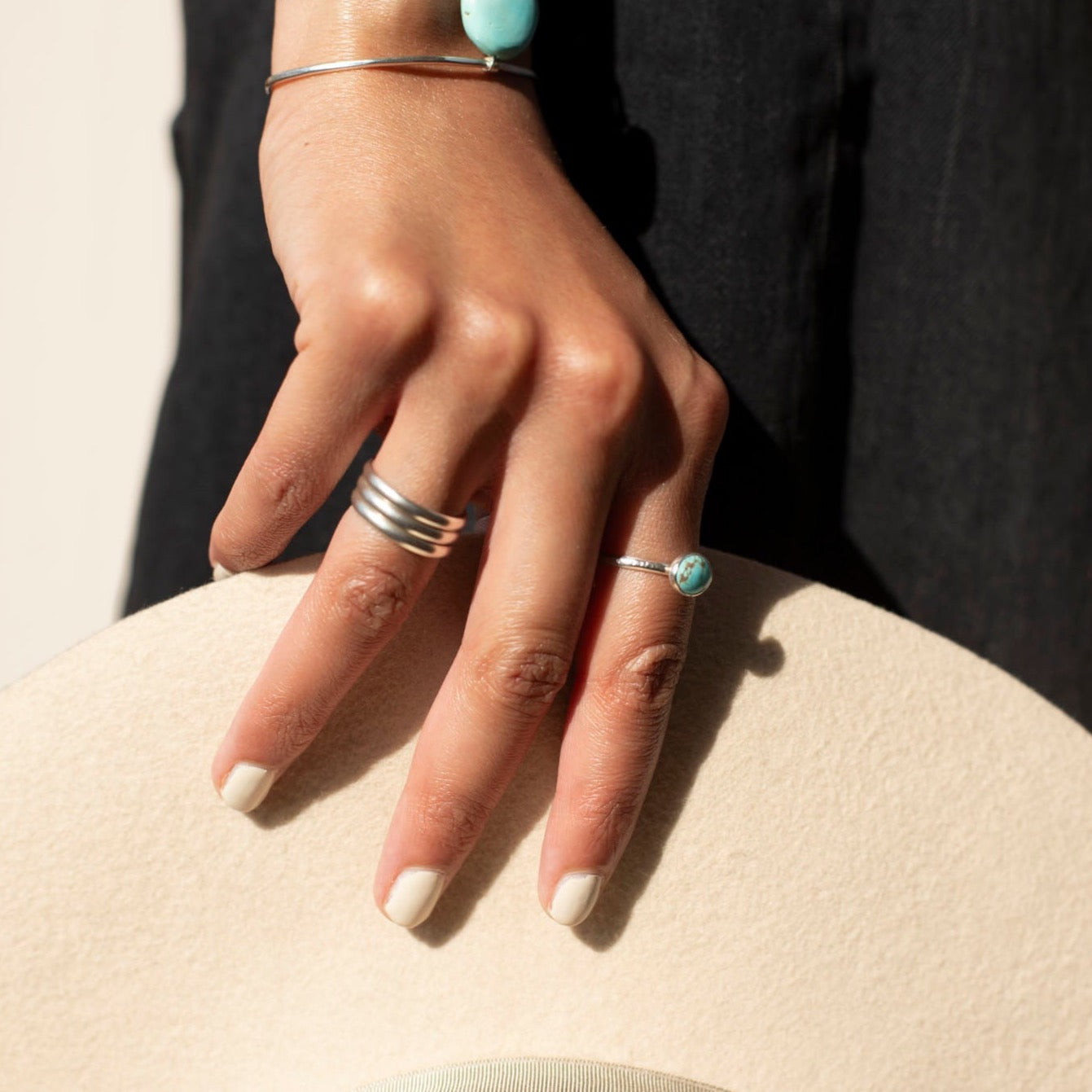 Model wearing 925 sterling silver Trinity Ring. This ring features the look of the three layered band look but its only one ring.