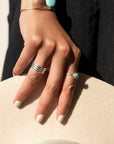 Model wearing 925 sterling silver Trinity Ring. This ring features the look of the three layered band look but its only one ring.