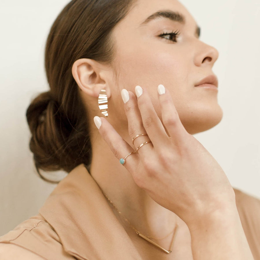 Model wearing  the 4 mm Turquoise Ring  on pointer finger along with a 14k gold fill double band ring worn on the middle finger.
