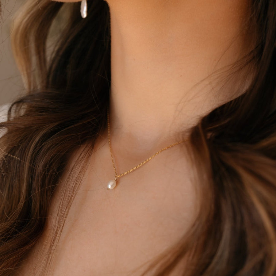 model wearing 14k gold fill floating pearl necklace.