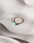 stone plate with a 14k gold fill ring set on the plate. The ring features a 4 mm turquoise stone.