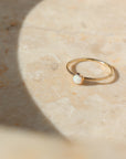 14k gold fill Opal Ring Place in the sunlight o a tan shone plate.