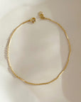 14k gold fill Sailor Bracelet set on a white plate in the sunlight. - Token Jewelry
