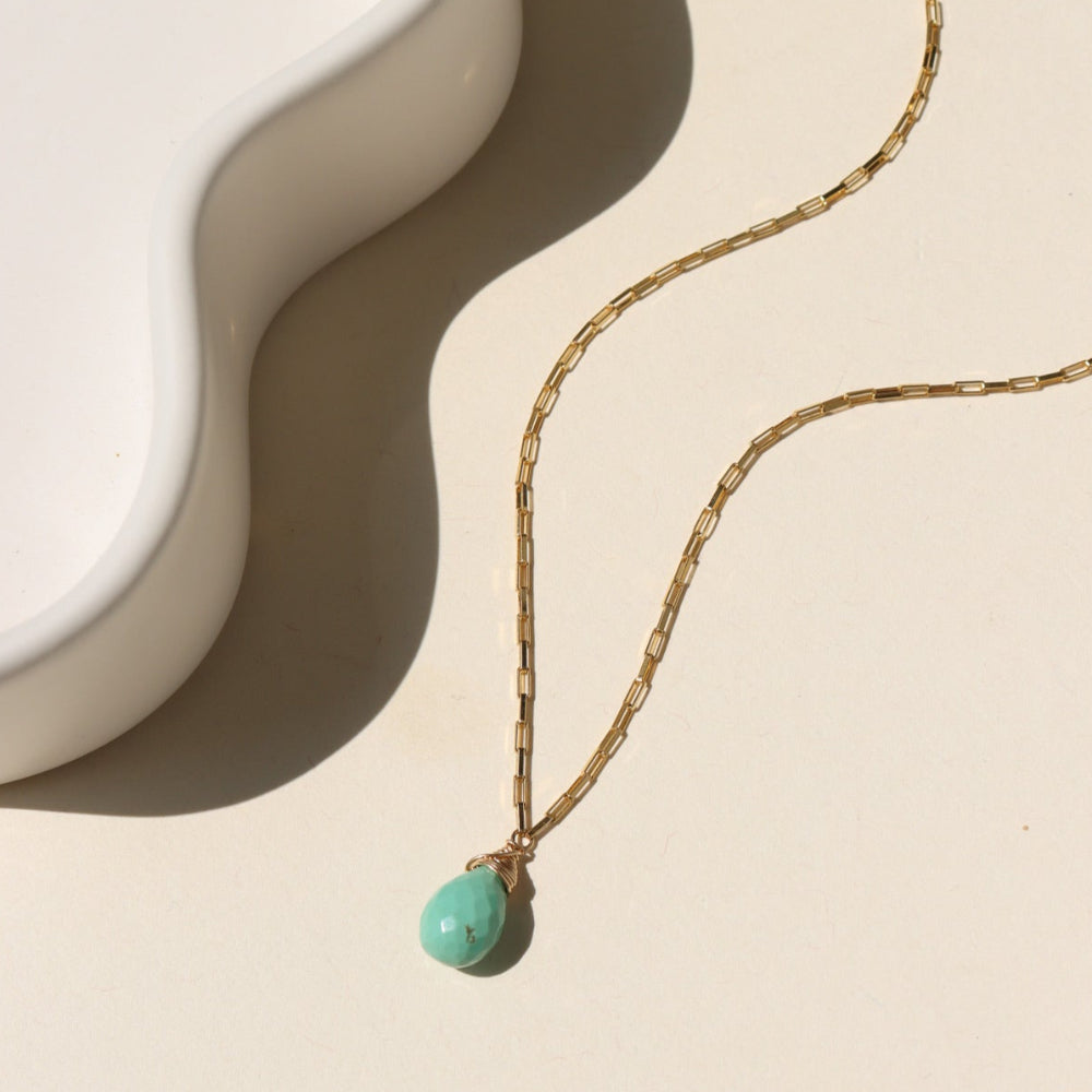 Agave Necklace with a faceted sage green turquoise teardrop pendant on a reflective gold filled box chain, designed for everyday wear and layering.