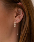 Model wearing sterling silver chain link drop earrings paired with a sterling silver bar stud and delicate chain threader earring with a freshwater pearl accent. Minimal layered ear stack.