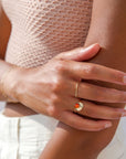 Model wearing Curved hammered stacking ring in gold fill with a rainbow-like arc shape