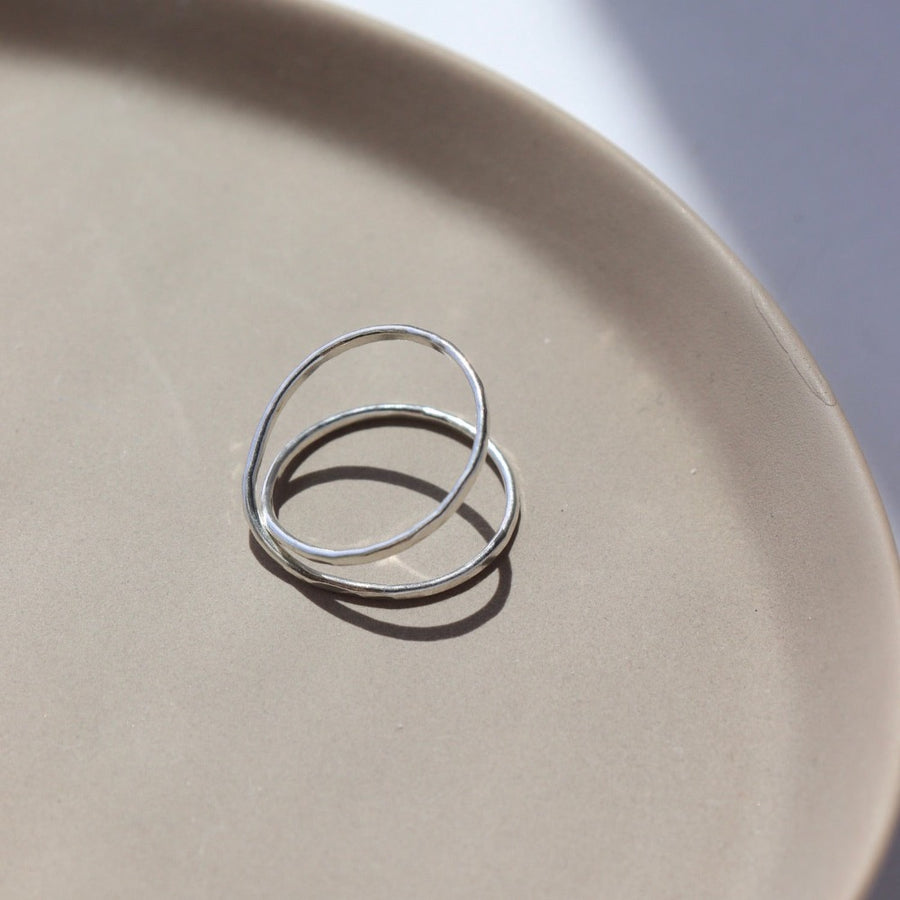 925 Sterling silver  infinity Ring laid on a tan plate. This Ring features the symbolism of the infinity meaning forever. Also makes it look like you are wearing two rings on the one finger. Super cute statement ring.