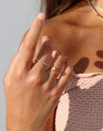 Model wearing fiery carnelian glow ring in gold fill setting
