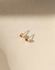 sterling silver bezel ear posts with 4mm citrine stone on a light background