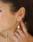 model wearing handmade 14k gold fill wire earrings with freshwater pearls