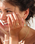 Model wearing a coral gemstone ring set in a 14k gold fill bezel