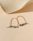 14k gold fill arch shaped earrings with dalmatian jasper & blue lace agate beads on a light background