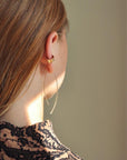 Red head model wearing our gold ebb and flows.