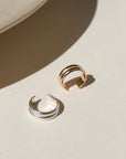 A 14k gold fill + sterling silver doubled layered ear cuff, displayed on a cream backdrop in the sunlight