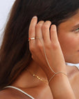 model wearing 14k gold fill hand chain with 14k gold fill rings
