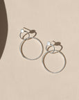 sterling silver stud earrings with handmade circle drops on a light background