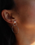 model wearing handmade drop earrings with pearl studs and hand crafted circles