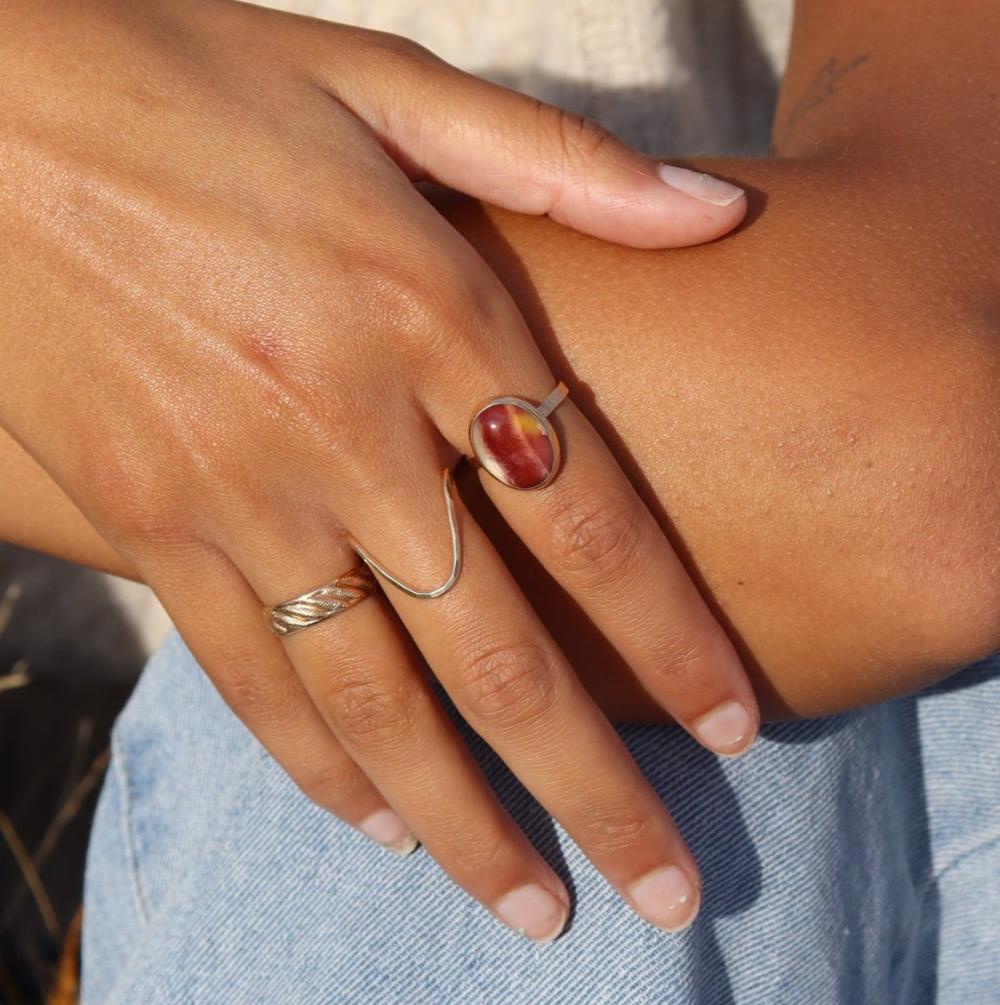 The Harvest Ring features a mookite gemstone encased in a pretty oval bezel, set within your choice of a textured 14k gold fill or sterling silver band.