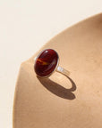 The Harvest Ring features a mookite gemstone encased in a pretty oval bezel, set within your choice of a textured 14k gold fill or sterling silver band.