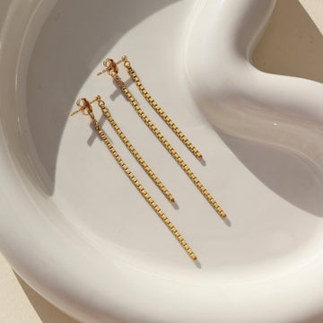 14k gold fill Dangle earrings laid on a white plate. Handmade in Eau Claire, Wisconsin. 