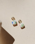 Floral ceramic cube charm with pastel vintage-inspired flowers and gold loop.