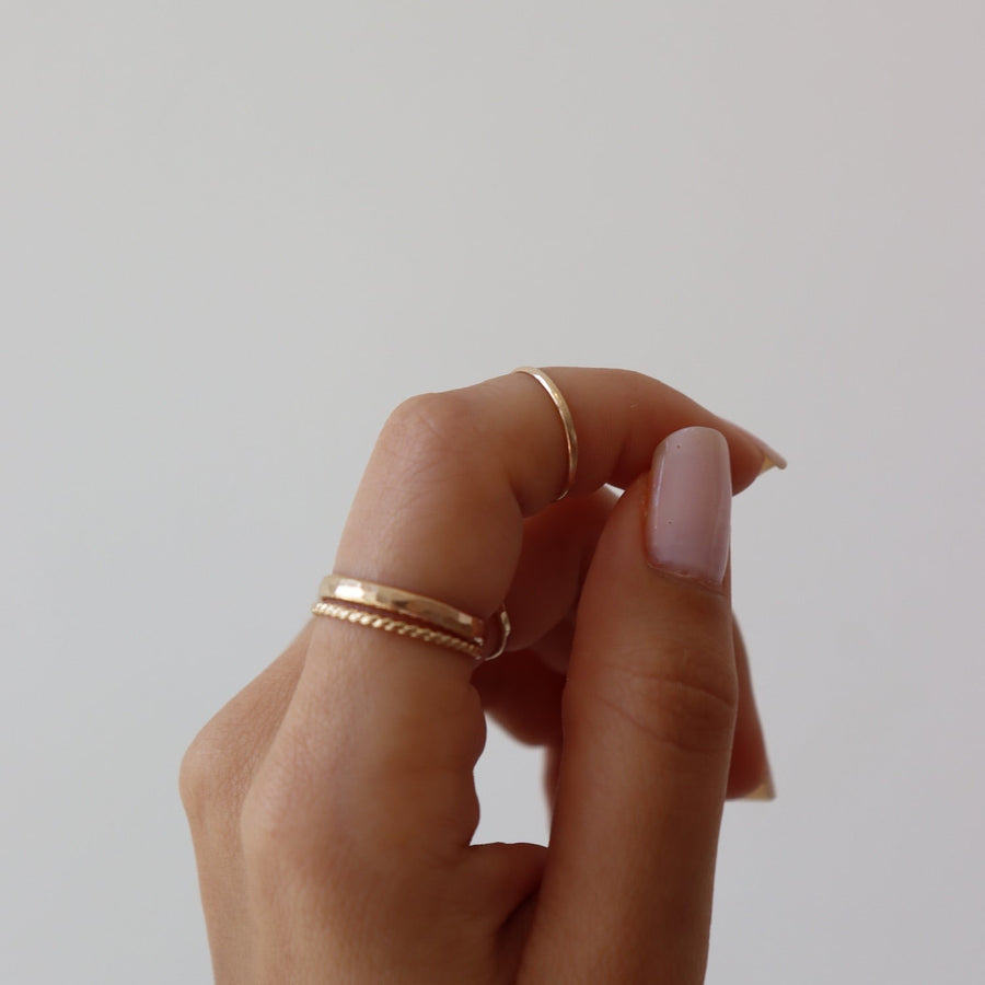 14k gold fill Minimal Midi Ring on models finger. This Ring features a simple band that is smooth perfect for everyday wear.