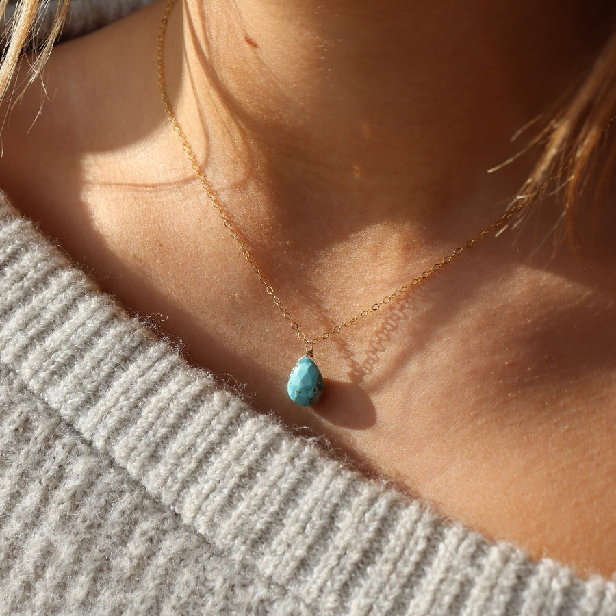 turquoise gemstone necklace pictured on a model