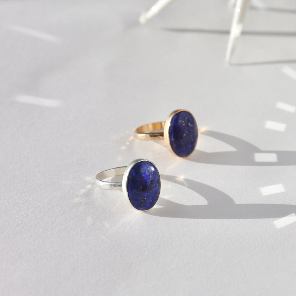 Lapis Lazuli Gemstone Ring in sterling silver and 14k gold fill, photographed on a white backdrop. This ring features a thick hammered band with a 12x16mm Lapis gemstone.