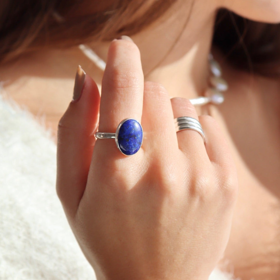 Lapis Lazuli Gemstone Ring in sterling silver photographed on a model. Lapis Lazuli Gemstone Ring in sterling silver. This ring features a thick silver hammered band with a 12x16mm Lapis gemstone.