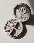 large lavender jewelry travel case opened with various 14k gold fill and gemstone jewelry