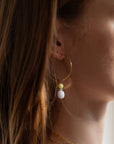 model wearing 14k gold fill hammered hoop earrings with jade and blue lace agate gemstone charms