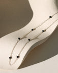 The Lennox Chain features smooth black tourmaline gemstones along a delicate cable chain—crafted in gold fill or sterling silver for balance and protection
