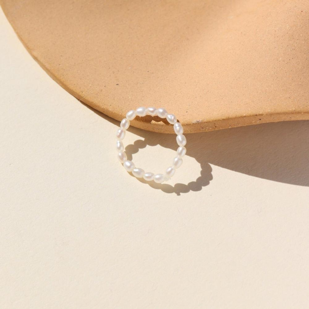 Margot ring laid on a tan plate in the sunlight.
