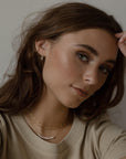 model wearing 14k gold fill staple shaped earrings