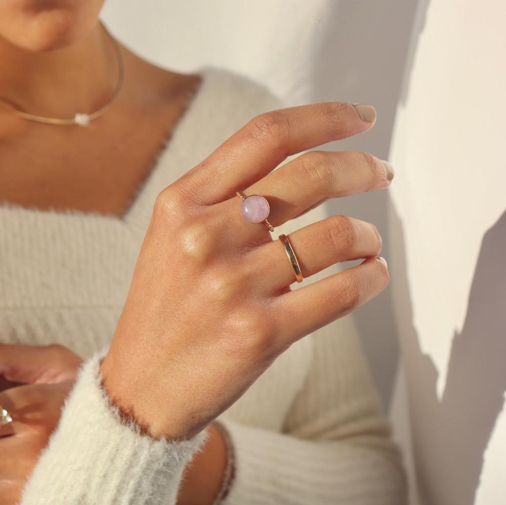 Model wearing our gold Pippa ring. This ring features a Pink Kunzite gemstone with a delicate spiral band.