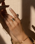 Model wearing 14k gold fill 4mm Moonstone Ring and other rings