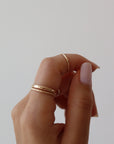14k gold fill Minimal Midi Ring on models finger. This Ring features a simple band that is smooth perfect for everyday wear.