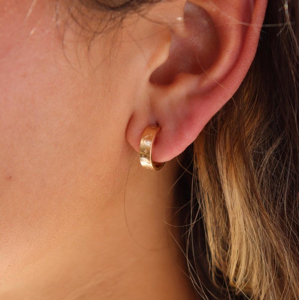 Model wearing 14k gold fill Starry Night Huggies