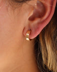 Model wearing 14k gold fill Starry Night Huggies