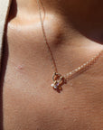 14k solid gold necklace made by Token Jewelry, featuring a simple chain and circle, with customizable birthstone charms, worn on a model