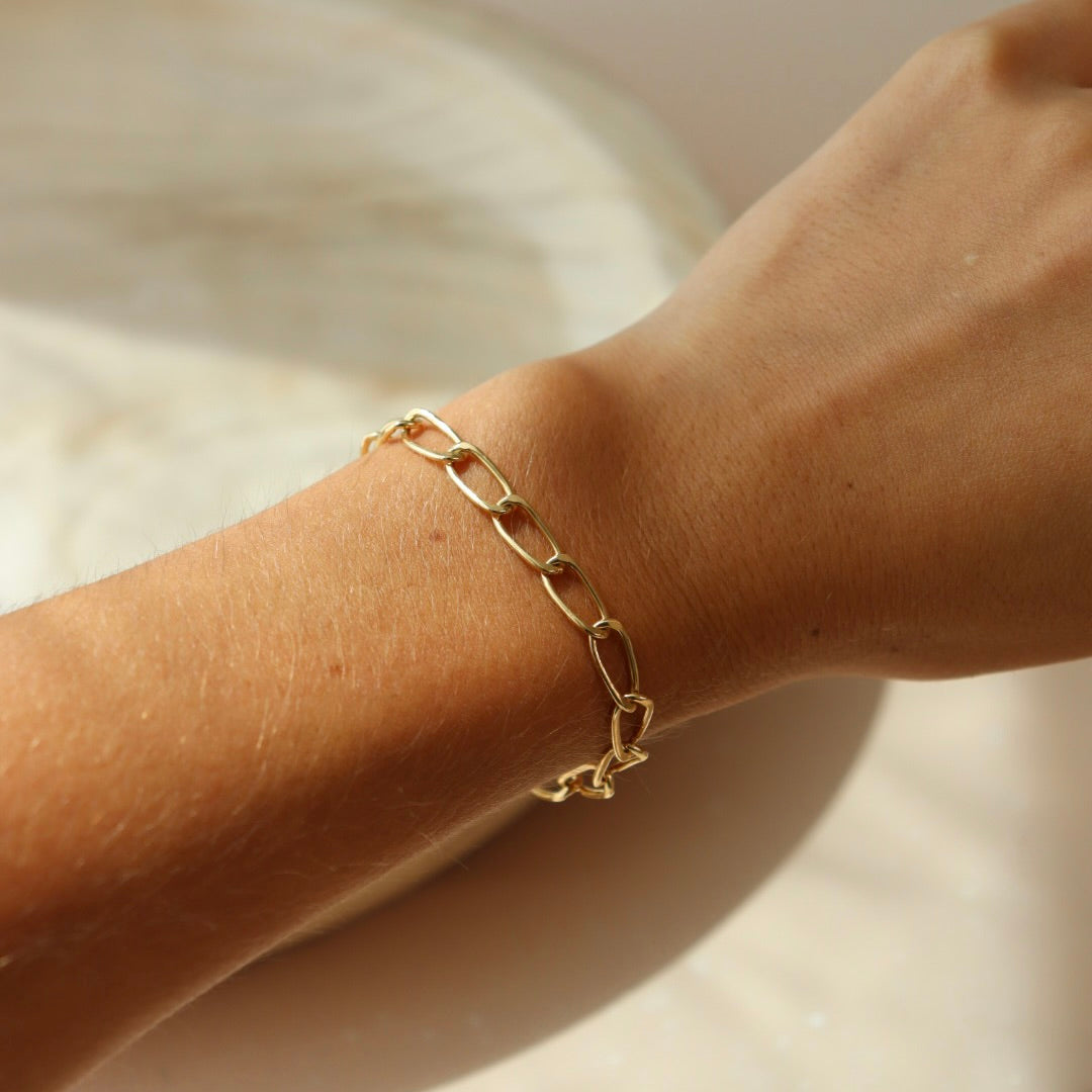 Model wearing the Curve Bracelet in 14k gold fill bracelet.