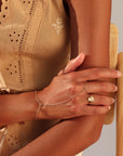 Model wearing stackable moonstone glow ring with iridescent shimmer in gold fill
