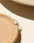 Close-up of stackable moonstone glow ring with iridescent shimmer in sterling silver