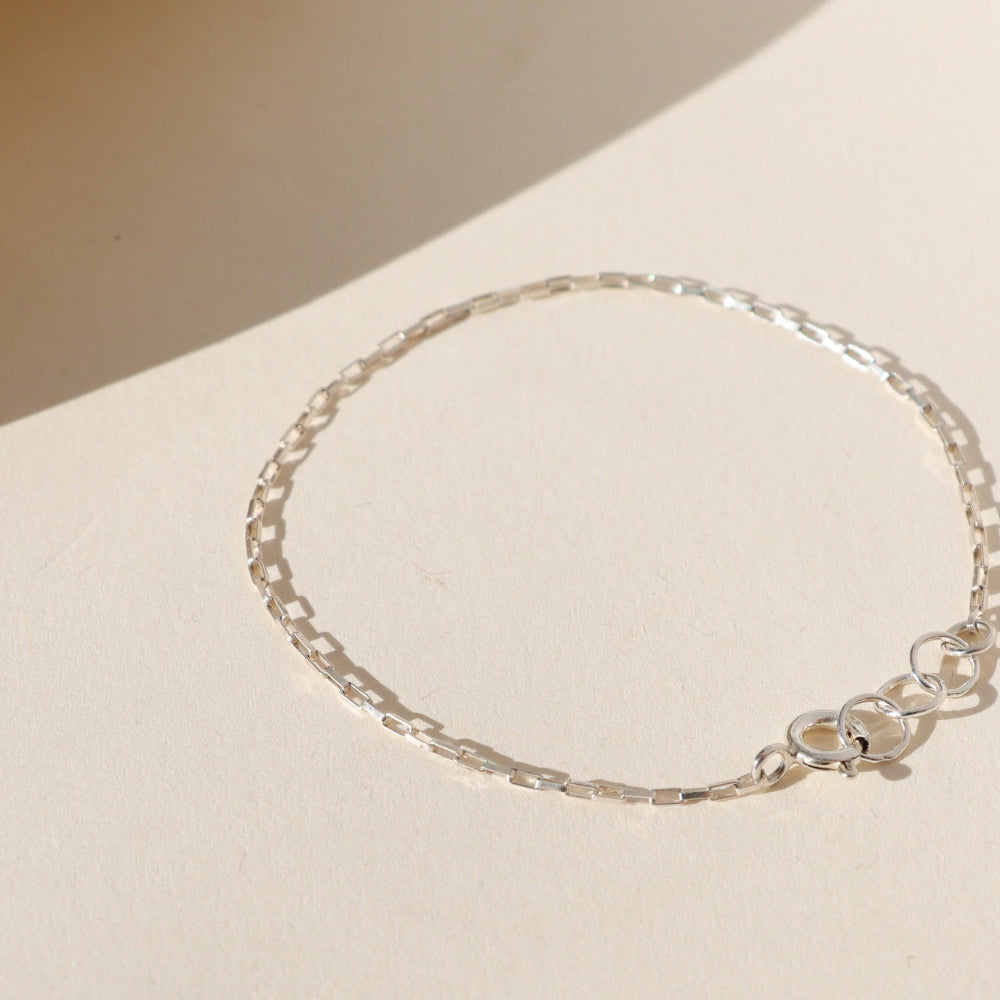 Nova Chain Bracelet in 14k gold fill or sterling silver, featuring a sleek box chain that reflects light with every movement
