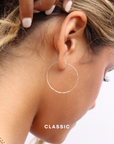 model wearing sterling silver hand made hammered hoop earrings