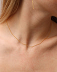 Remy chain necklace in 14k gold fill featuring delicate beaded chain links, worn on a model as a minimalist everyday layering necklace.