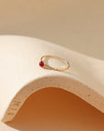 4mm ruby stone set in a 14k gold fill ring setting in the sunlight