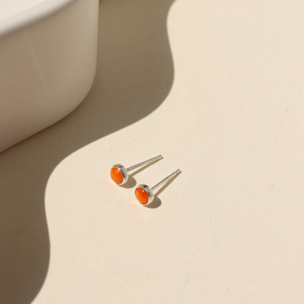 Sienna Studs featuring 4mm fiery orange spiny oyster cabochons in sterling silver bezel settings.