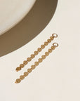 14k gold fill connectors featuring a long circle chain, dropped from a 4mm jump ring, displayed on a cream back drop in the sunlight